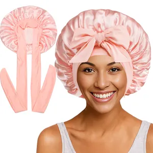 Détail du bonnet de nuit en satin rose avec long ruban porté par un mannequin