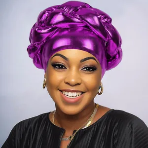 Detail of metallic purple braided turban showing shimmering fabric and twisted texture