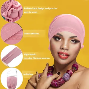 Pink breathable turban hat with large decorative flower knot and elastic fabric design