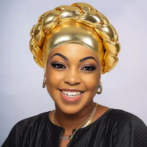 Detailed view of gold metallic braided turban cap with oversized thick twist design