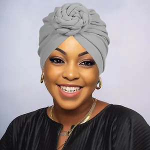 Detail view of a gray turban hat featuring a handcrafted knit twist knot for women