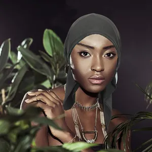 Detail of breathable black headscarf fabric and side ties on a female model