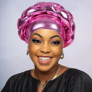 Close-up of pink metallic turban with twisted braid design and glossy texture finish
