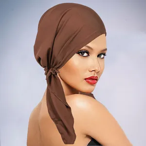 Close-up detail of smooth dark brown elastic turban hat fabric with a stylish knot design