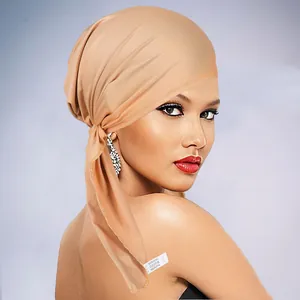 Detail of soft breathable turban hat with long ties and 100% polyester fabric texture