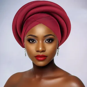 Detailed close-up of a large pleated red African Gele turban wrap on a female model