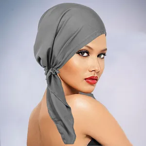 Detail of grey soft knit turban with side knot and long decorative ribbon ties