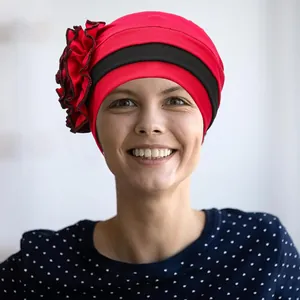Red turban hat with black contrast band and oversized side flower for women fashion