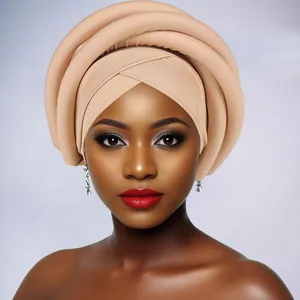 Close-up of beige layered sponge twist turban with structured multi-ring African style wrap