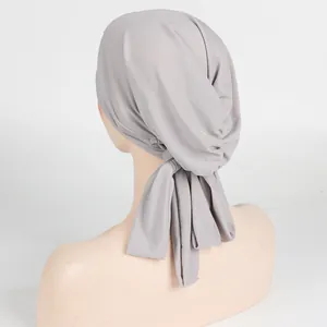 Grey ribbed high-stretch turban with cross forehead straps and long ties rear view