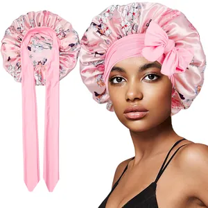 Detail of floral satin bonnet showing long adjustable ribbons and smooth silky texture