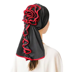 Black milk silk turban hat for women with red floral pleated trim and draped design