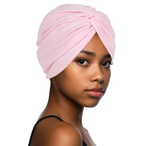 Close-up of light pink turban hat with soft fabric and front twisted knot detail