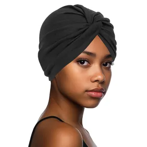 Detail of black twisted knot turban hat with elastic fabric texture on a female model
