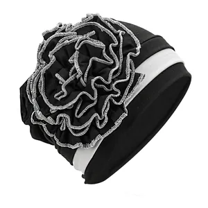Detail of side flower turban with silver edging and elastic fabric texture