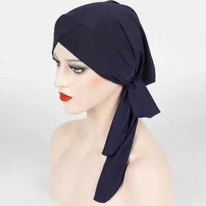 Close-up of deep purple ribbed knit turban hat with cross-tie design and soft texture