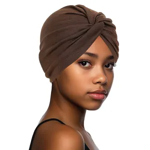 Detail of a dark brown twisted turban hat with textured cotton fabric on a model