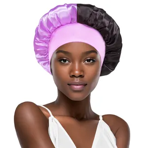 Detail of pink and black satin hair bonnet showing the smooth texture and wide elastic band