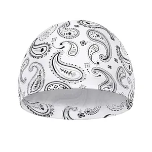 Close-up of white paisley skull cap featuring detailed black pattern and elastic stitching
