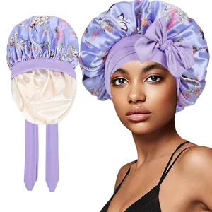 Detail view of double-layer satin sleep bonnet with purple floral print and long ribbons