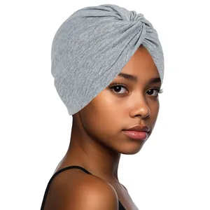 Detail view of heather gray knit turban hat featuring front twist knot on female model