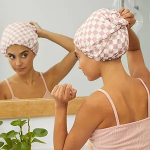 Detail view of pink checkerboard waterproof shower cap with soft satin lining in bathroom