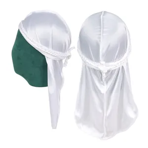 Close-up of white silky durag featuring braided edge details and elegant long tail draping