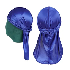 Detail of royal blue silky durag featuring braided straps and shiny satin fabric