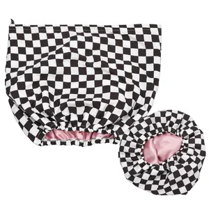 Detail of two-piece checkerboard shower caps with pink silk lining and elastic bands