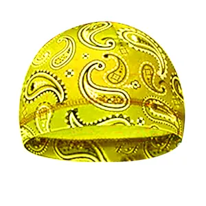 Detail of high-elastic paisley skull cap with vibrant yellow background and white patterns
