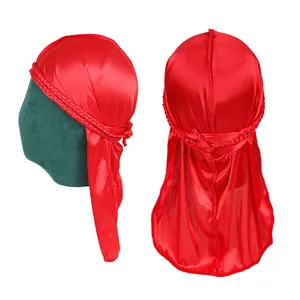 Detail view of red silky durag featuring braided trim and textured satin fabric