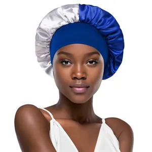 Detail of silk satin sleep bonnet featuring a two-tone blue and silver design with wide band