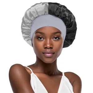 Detail view of two-tone satin hair bonnet with wide elastic band in silver and black
