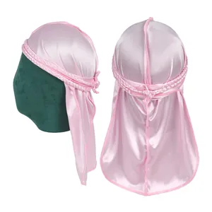 Detailed view of pink silky durag with braided straps and polished satin texture