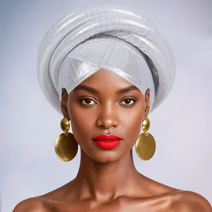 Detail of silver pleated African Gele turban and large layered gold disc earrings
