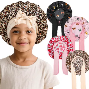 Kids satin sleep bonnet featuring vibrant prints and a stylish adjustable bow headband