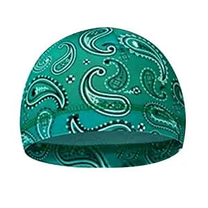 Detailed view of reinforced double-line stitching on green paisley cycling cap