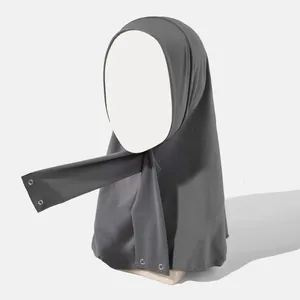 Detail view of dark grey elastic hijab with adjustable metal snap buttons for a secure fit