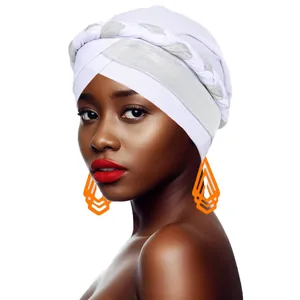 Close-up of white turban with braided headband detail and orange geometric earrings