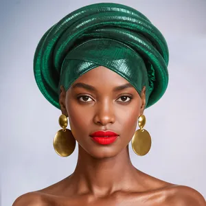Macro detail of metallic green African Gele headwrap with elegant pleated texture and gold earrings