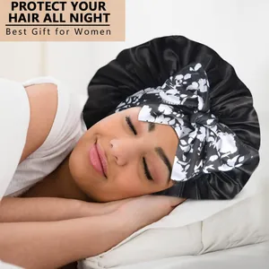 Black silk satin sleep bonnet with white floral bow detail for long hair protection