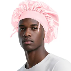 Detail of pink satin sleep cap with wide elastic band and adjustable front tie strings