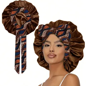 Detail showing the brown satin fabric and colorful Ankara print strap of the sleeping bonnet