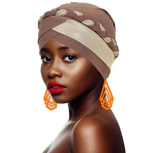 Detail of cross front turban with brown fabric and braided gold metallic thread detail