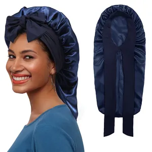 Detail of dark blue satin long hair bonnet with wide elastic ribbon and large bow design