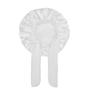 Detail of white satin kids sleep cap featuring long adjustable ribbons and silky texture