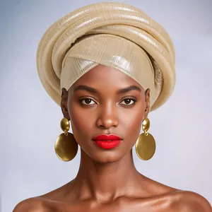 Close-up of metallic gold pleated turban wrap and matching round drop earrings