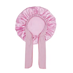 Detail of pink satin sleep bonnet with adjustable wide straps for hair protection