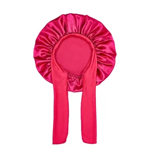 Detailed view of magenta satin sleep bonnet with long adjustable straps and elastic edge