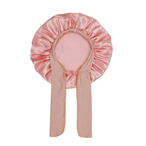 Close-up of pink satin kids bonnet featuring silky texture and adjustable long ribbons